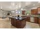 Open-concept kitchen with granite countertops, stainless steel appliances, island, and seamless flow to dining and living at 5060 S Clancy --, Mesa, AZ 85212