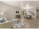 Inviting living room and dining area with tile flooring, neutral tones and an elegant staircase at 5060 S Clancy --, Mesa, AZ 85212
