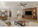 Open concept living room with brick accent wall and eat-in kitchen at 5060 S Clancy --, Mesa, AZ 85212