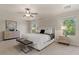 Serene main bedroom features plush carpet, a ceiling fan, and bright windows at 5060 S Clancy --, Mesa, AZ 85212