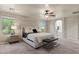 Comfortable main bedroom suite with plush carpet and bright ensuite bathroom at 5060 S Clancy --, Mesa, AZ 85212