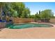 Private backyard pool surrounded by lush landscaping and concrete deck at 5060 S Clancy --, Mesa, AZ 85212