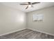 This bedroom features a ceiling fan, hardwood flooring, and a large window, perfect for comfort and style at 6625 N 44Th Ave, Glendale, AZ 85301