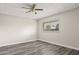 Simple bedroom with ceiling fan, wood-look floors, and a window that provides natural light at 6625 N 44Th Ave, Glendale, AZ 85301