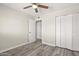 Bedroom featuring a ceiling fan, closet, neutral walls, and wood-look flooring at 6625 N 44Th Ave, Glendale, AZ 85301