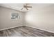 Empty bedroom boasts wood-look floors, baseboards, and natural light from a window at 6625 N 44Th Ave, Glendale, AZ 85301