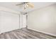 Bedroom with sleek wood-look floors, a ceiling fan, and closet storage at 6625 N 44Th Ave, Glendale, AZ 85301