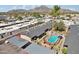 Aerial view of community pool and surrounding buildings with mountain views at 6739 N 16Th St # 17, Phoenix, AZ 85016