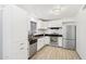 Bright kitchen featuring stainless steel appliances, white cabinets, and wood plank flooring at 6739 N 16Th St # 17, Phoenix, AZ 85016