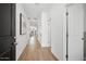 Bright hallway with wood-look flooring leading to the dining room and bedrooms at 7435 S 76Th Dr, Laveen, AZ 85339