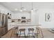 Bright, eat-in kitchen features a modern island with pendant lighting and stainless steel appliances at 7435 S 76Th Dr, Laveen, AZ 85339