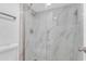 Walk in shower features seamless glass, rain head shower fixture, and decorative tile at 7777 E Main St # 215, Scottsdale, AZ 85251