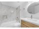Bathroom featuring a shower-tub combination with decorative marble-look tile at 7777 E Main St # 215, Scottsdale, AZ 85251
