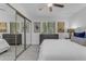 Bedroom featuring tiled floor, a large window, and a mirrored closet for ample storage at 7777 E Main St # 215, Scottsdale, AZ 85251