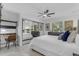 Bright bedroom featuring mirrored closets, a ceiling fan, and a dedicated workspace at 7777 E Main St # 215, Scottsdale, AZ 85251