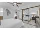 Bright bedroom featuring a ceiling fan, desk area, and mirrored closet for ample storage at 7777 E Main St # 215, Scottsdale, AZ 85251