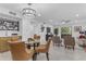 Open-concept dining area with a glass table, leather chairs, and a view of the living room at 7777 E Main St # 215, Scottsdale, AZ 85251