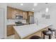 Bright kitchen with stainless steel appliances, white countertops, and seating at the island at 7777 E Main St # 215, Scottsdale, AZ 85251