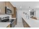Updated kitchen features stainless steel appliances, light wood cabinetry, and a sleek backsplash at 7777 E Main St # 215, Scottsdale, AZ 85251