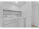 Image of a laundry room with full sized white appliances, and folding doors at 7777 E Main St # 215, Scottsdale, AZ 85251
