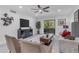 Inviting living room with comfortable seating, a large TV, and sliding glass doors to the balcony at 7777 E Main St # 215, Scottsdale, AZ 85251