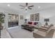 Comfortable living room featuring plush seating, a ceiling fan, and bright, natural light at 7777 E Main St # 215, Scottsdale, AZ 85251