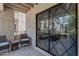 Cozy outdoor patio with seating and views of the living room through sliding glass doors at 7777 E Main St # 215, Scottsdale, AZ 85251