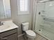 Bathroom featuring a sink, toilet, and a glass shower at 8330 N 22Nd Ln, Phoenix, AZ 85021