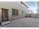 Gravel backyard with a door, window, and an air conditioner at 840 E Agua Fria Ln, Avondale, AZ 85323