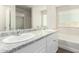 Bright bathroom featuring double sinks, white cabinets and a large mirror at 840 E Agua Fria Ln, Avondale, AZ 85323