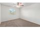 Bedroom features carpet, ceiling fan, and window to outside at 840 E Agua Fria Ln, Avondale, AZ 85323
