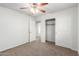Bedroom featuring carpet, ceiling fan, closet, and easy access to other rooms at 840 E Agua Fria Ln, Avondale, AZ 85323
