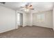 Spacious bedroom featuring a ceiling fan, carpet floors and multiple windows for ample light at 840 E Agua Fria Ln, Avondale, AZ 85323