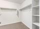 Walk-in closet features shelving and hanging racks for organized storage space at 840 E Agua Fria Ln, Avondale, AZ 85323