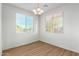 Bright dining room featuring wood-look floors, modern lighting, and dual windows at 840 E Agua Fria Ln, Avondale, AZ 85323