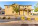 Charming two-story home featuring a welcoming front porch and low-maintenance desert landscaping at 840 E Agua Fria Ln, Avondale, AZ 85323