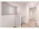 Hallway with carpet, neutral colored walls, a window, and a railing at 840 E Agua Fria Ln, Avondale, AZ 85323