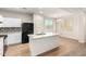 Bright kitchen showcasing the center island with sink, granite countertops, and white cabinetry at 840 E Agua Fria Ln, Avondale, AZ 85323