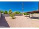 Wide shot of backyard with desert rock, plants, and block fence. Room for recreation at 915 E Commonwealth Pl, Chandler, AZ 85225