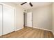 Bedroom with a ceiling fan, closet, and wood-look floors at 915 E Commonwealth Pl, Chandler, AZ 85225