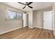 Spacious bedroom featuring wood-look floors and a large window at 915 E Commonwealth Pl, Chandler, AZ 85225