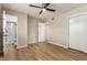 Bedroom with wood-look floors, ceiling fan, and access to bathroom at 915 E Commonwealth Pl, Chandler, AZ 85225
