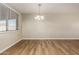 Dining room with new lighting, window, and wood-look flooring at 915 E Commonwealth Pl, Chandler, AZ 85225