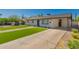 Well-kept home with green grass and cracked concrete driveway at 915 E Commonwealth Pl, Chandler, AZ 85225