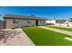 Inviting home exterior with a green lawn, paved walkway, and mature landscaping at 915 E Commonwealth Pl, Chandler, AZ 85225