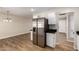 Kitchen view with stainless steel refrigerator and wood-look flooring at 915 E Commonwealth Pl, Chandler, AZ 85225