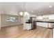 Open kitchen featuring stainless steel appliances, white cabinets, and wood-look floors at 915 E Commonwealth Pl, Chandler, AZ 85225