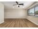Neutral living room featuring wood-look floors, ceiling fan, and recessed lighting at 915 E Commonwealth Pl, Chandler, AZ 85225