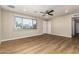 Spacious living room with wood-look floors, a ceiling fan, and ample natural light at 915 E Commonwealth Pl, Chandler, AZ 85225