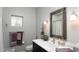 Stylish bathroom with a marble countertop, updated fixtures, and ample natural light and updated mirror at 943 E Kortsen Rd # 10, Casa Grande, AZ 85122